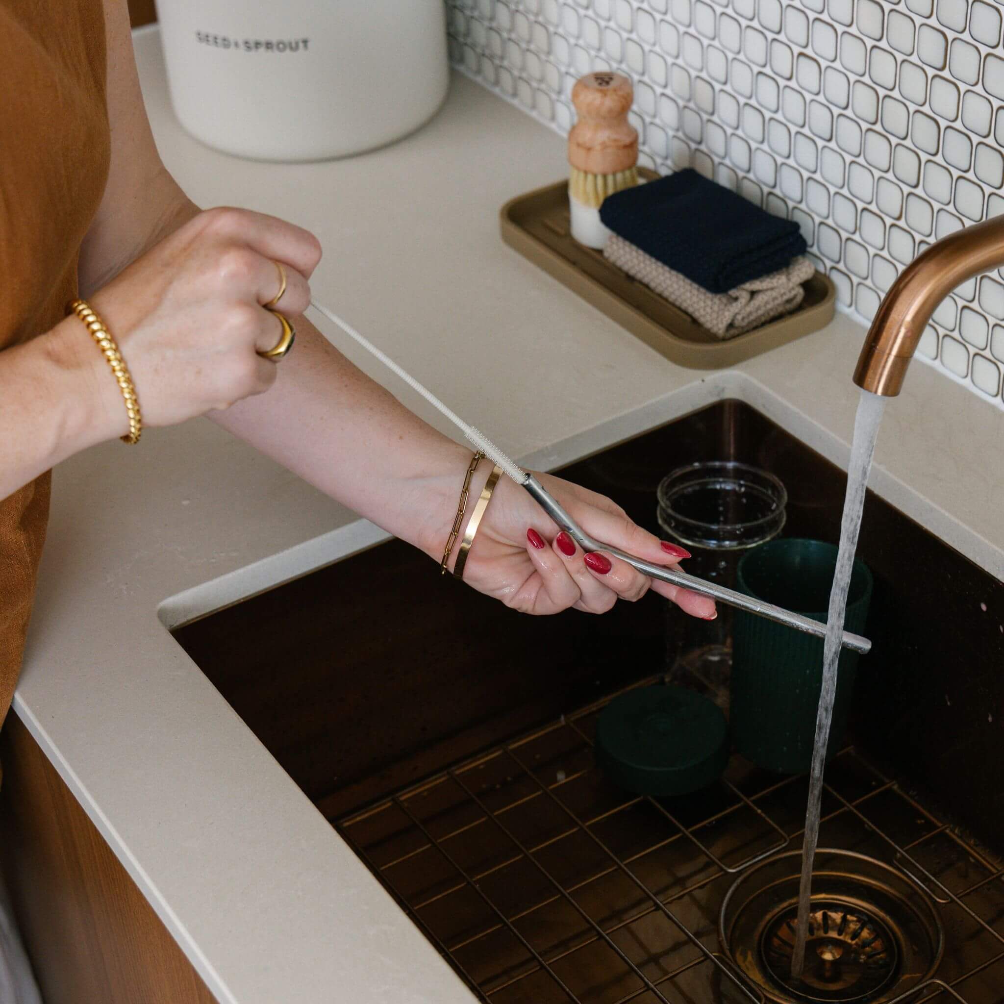 the stainless steel low tox straw being washed