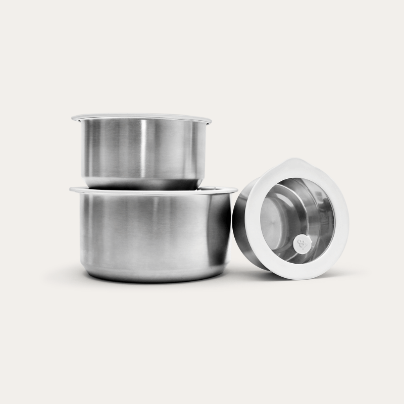 Set of three round stainless steel food storage containers with clear tempered glass airtight lids, showing different sizes.