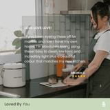 5-star customer review from Mikaela C. overlaid on a lifestyle photo of a person using a Wood Fibre Chopping Board in Mushroom on a dark kitchen countertop. Review reads: "Easy to clean, low toxic and incredibly light plus a beautiful colour that matches my new kitchen."