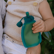 child holding reusable yoghurt pouch