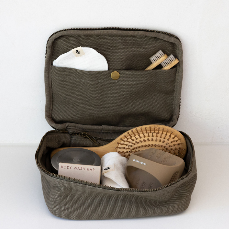 a GOTS Certified Organic Cotton personal organizer bag with items inside that range from hairbrushes to toothbrushes